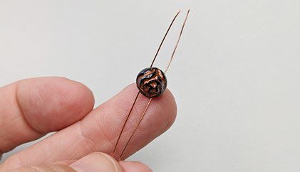 Rose bead with folded wire threaded through it